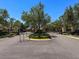 View of the neighborhood entrance with iron gates, landscaping, and decorative columns at 2630 Milford Berry Ln, Tampa, FL 33618