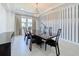 Formal dining room showcases modern light fixture, seating for six, and decorative wine storage rack at 2630 Milford Berry Ln, Tampa, FL 33618