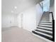 Bright foyer with tile flooring, staircase with black accents, and a front door, creating an inviting entrance at 2630 Milford Berry Ln, Tampa, FL 33618
