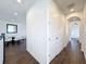 Hallway featuring dark wood floors, and white doors leading to other rooms at 2630 Milford Berry Ln, Tampa, FL 33618
