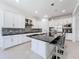 Modern kitchen features white cabinetry, granite countertops, and stainless steel appliances at 2630 Milford Berry Ln, Tampa, FL 33618