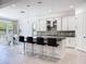 Bright, open kitchen with center island, modern appliances, and adjacent dining area at 2630 Milford Berry Ln, Tampa, FL 33618