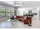 Spacious living room features a leather sofa, modern glass tables, and tile flooring at 2630 Milford Berry Ln, Tampa, FL 33618