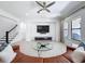 Living room boasts tile flooring, neutral walls, with a large tv, and a glass coffee table at 2630 Milford Berry Ln, Tampa, FL 33618