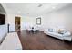 Bright living room featuring dark wood floors, a modern dining set, and a sleek white sofa at 2630 Milford Berry Ln, Tampa, FL 33618