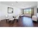 Open living space featuring modern furniture, dark wood floors, and ample natural light at 2630 Milford Berry Ln, Tampa, FL 33618