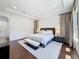 Bright main bedroom featuring wood floors, recessed lighting, and patterned curtains at 2630 Milford Berry Ln, Tampa, FL 33618
