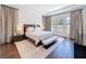 Relaxing main bedroom features an abundance of natural light, stylish furnishings, and wood floors at 2630 Milford Berry Ln, Tampa, FL 33618