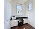 Bright office space with a built-in desk, ample natural light, and white cabinetry, perfect for a home office setup at 2630 Milford Berry Ln, Tampa, FL 33618