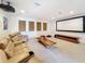Inviting theater room featuring plush seating, a large projection screen, and a contemporary coffee table at 2630 Milford Berry Ln, Tampa, FL 33618