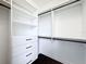 Organized walk-in closet featuring built-in shelving, drawers, and dark hardwood floors at 2630 Milford Berry Ln, Tampa, FL 33618