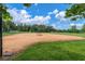 Community baseball field surrounded by lush greenery, with soccer goals and a clear blue sky in the background at 3465 Bumelia Ln, New Port Richey, FL 34655