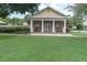 Charming community clubhouse features a welcoming entrance and lush landscaping for residents to gather and socialize at 3465 Bumelia Ln, New Port Richey, FL 34655