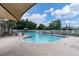 Enjoy the community pool with ample seating, shade, and a pristine fenced-in area for relaxing and swimming at 3465 Bumelia Ln, New Port Richey, FL 34655