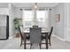Bright dining area with modern table setting, pendant lighting, and stainless steel appliances at 3465 Bumelia Ln, New Port Richey, FL 34655