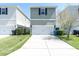 Exterior view of modern two-story home with a well-maintained lawn at 3465 Bumelia Ln, New Port Richey, FL 34655