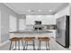 Modern kitchen with granite countertops, stainless steel appliances and a breakfast bar with seating at 3465 Bumelia Ln, New Port Richey, FL 34655