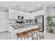 Bright kitchen featuring white cabinets, stainless steel appliances, and a granite island with seating at 3465 Bumelia Ln, New Port Richey, FL 34655