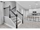 Open-concept home design featuring kitchen with white cabinets, stainless appliances, and barstool seating at 3465 Bumelia Ln, New Port Richey, FL 34655