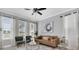 Bright living room featuring a leather couch, stylish decor, and plenty of natural light at 3465 Bumelia Ln, New Port Richey, FL 34655