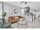 Cozy living room featuring a leather couch, sleek stairs, and stylish decor at 3465 Bumelia Ln, New Port Richey, FL 34655