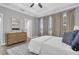 Serene main bedroom with neutral tones, large windows, and a tray ceiling at 3465 Bumelia Ln, New Port Richey, FL 34655