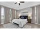Inviting main bedroom featuring large windows, ceiling fan, and neutral decor at 3465 Bumelia Ln, New Port Richey, FL 34655