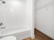 Bright bathroom features a tub with white subway tile and a wire rack closet at 3592 Arrowhead Ave, Spring Hill, FL 34606