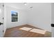 Bright bedroom features wood-look flooring, a window view and white walls at 3592 Arrowhead Ave, Spring Hill, FL 34606