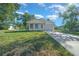 Charming single-story home with white siding, a front porch, and a well-manicured lawn at 3592 Arrowhead Ave, Spring Hill, FL 34606