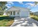 Charming single-story home with white siding, a front porch, and an attached one car garage at 3592 Arrowhead Ave, Spring Hill, FL 34606