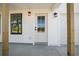 Close up of the front entrance with a glass front door, porch lights, and black framed windows at 3592 Arrowhead Ave, Spring Hill, FL 34606