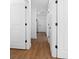 This hallway shows neutral paint, luxury vinyl plank flooring, and white doors at 3592 Arrowhead Ave, Spring Hill, FL 34606