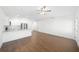 Open concept living room with kitchen, stainless steel appliances, wood flooring, and ample natural light at 3592 Arrowhead Ave, Spring Hill, FL 34606