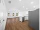 Spacious open concept living room with kitchen, stainless steel appliances, wood flooring, and ceiling fan at 3592 Arrowhead Ave, Spring Hill, FL 34606
