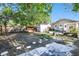 Large backyard showcasing mature trees, wooden fencing, a storage shed and stepping stones to the home at 4725 3Rd S Ave, St Petersburg, FL 33711