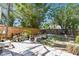 Landscaped backyard featuring a stone paver patio surrounded by lush greenery and a wooden fence at 4725 3Rd S Ave, St Petersburg, FL 33711