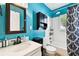 Stylish bathroom features a shower-tub combo, framed mirror, and storage at 4725 3Rd S Ave, St Petersburg, FL 33711