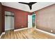 This bedroom has laminate flooring, a ceiling fan, and a walk-in closet at 4725 3Rd S Ave, St Petersburg, FL 33711