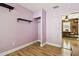 Small bedroom with hardwood floors and shelves, adjacent to hallway at 4725 3Rd S Ave, St Petersburg, FL 33711