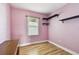 Bedroom with hardwood floors, pink walls, and a window providing natural light at 4725 3Rd S Ave, St Petersburg, FL 33711