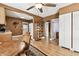 Open dining area with wood floors, connecting to kitchen and featuring a glass display cabinet at 4725 3Rd S Ave, St Petersburg, FL 33711