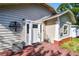 Charming home featuring a welcoming front door with red wood deck and decorative light fixture at 4725 3Rd S Ave, St Petersburg, FL 33711