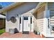 Close up of the front door with a decorative metal flourish above a small deck at 4725 3Rd S Ave, St Petersburg, FL 33711