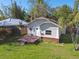A quaint single-Gathering home featuring a inviting front porch and lush greenery, perfect for relaxed living at 4725 3Rd S Ave, St Petersburg, FL 33711