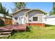 Charming home featuring a quaint front porch, well-maintained lawn, and beautiful landscaping at 4725 3Rd S Ave, St Petersburg, FL 33711
