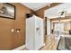 View of refrigerator and pantry with kitchen access, leading to the living areas at 4725 3Rd S Ave, St Petersburg, FL 33711