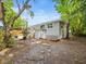 Backyard exterior view featuring a partial view of the home's outdoor patio and surrounding trees at 4816 N Highland Ave, Tampa, FL 33603