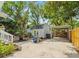 Backyard view showcasing a shed, carport, garden bed, patio, and an assortment of leafy shade trees at 4816 N Highland Ave, Tampa, FL 33603