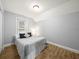 Cozy bedroom with wood floors, a gray bedspread, and a window with natural light at 4816 N Highland Ave, Tampa, FL 33603